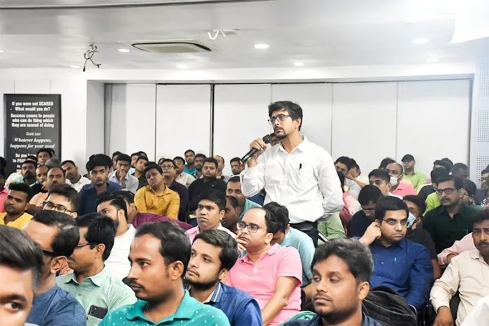 Attendee asking a question during the seminar